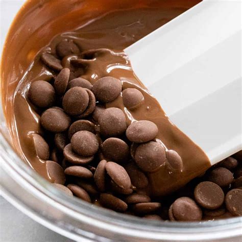 Break up the chocolate into pieces, add them to the bowl and, keeping the heat at its lowest, leave the chocolate to melt slowly. The chocolate will take about 10 minutes to melt and become smooth and glossy. (Though the time will vary depending on the amount of chocolate – individual timings are given in each recipe.) Then remove it from the ...